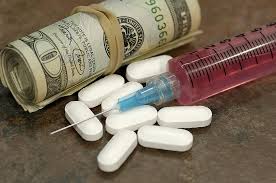 Syringe, pills & roll of cash bills